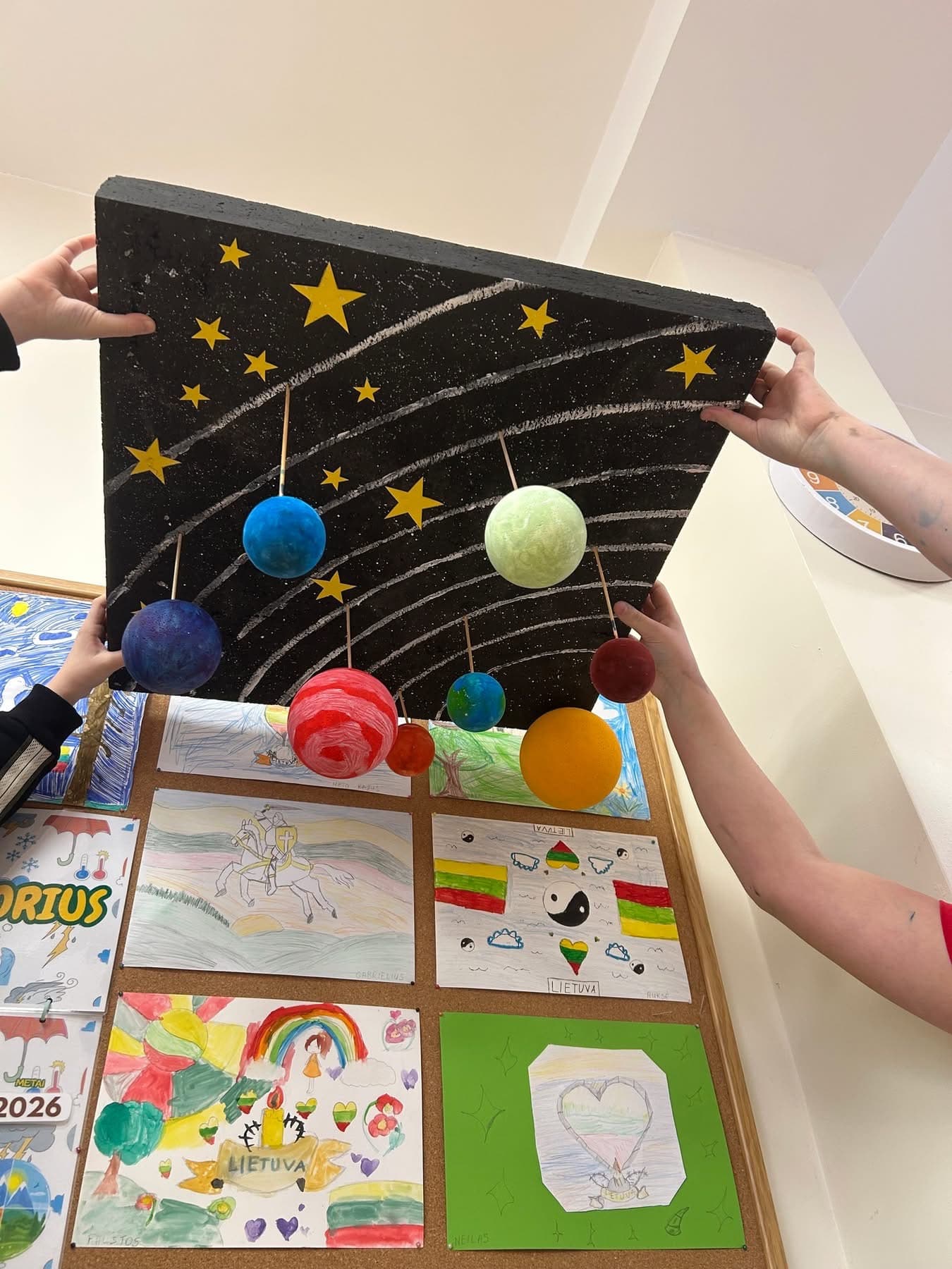 Student-made solar system model with painted planets