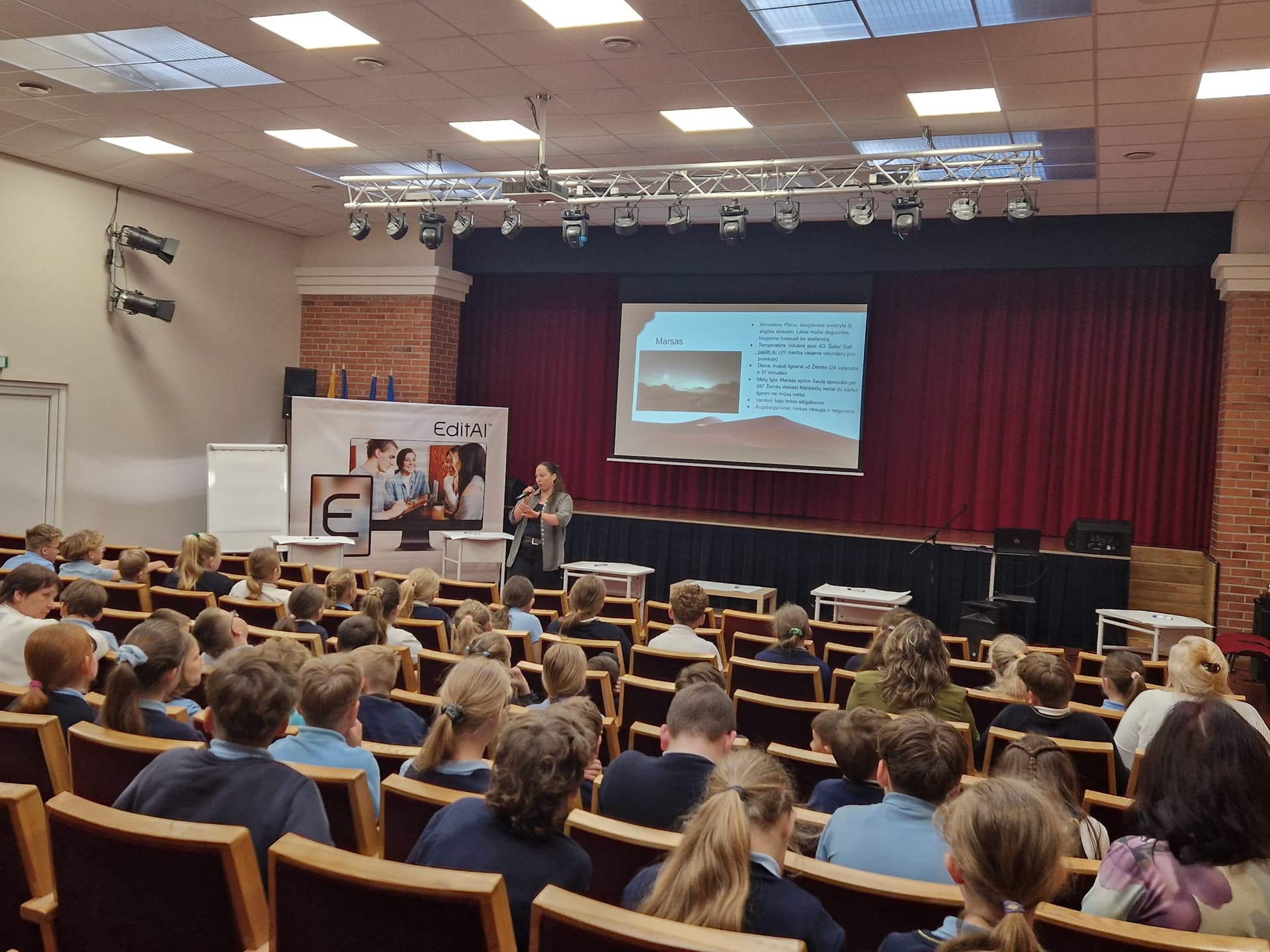 Students watching a presentation in the auditorium
