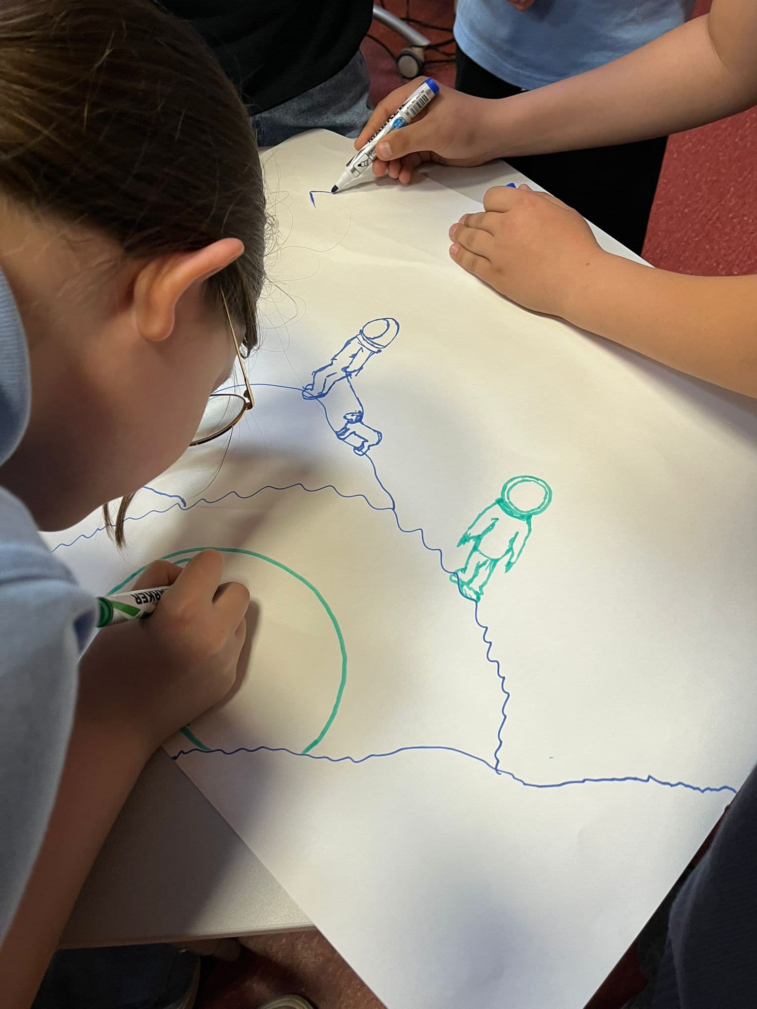 Student drawing on a creative project