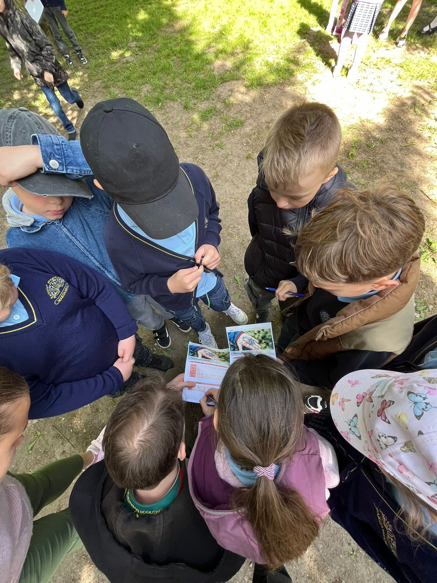 Students huddled together examining project materials
